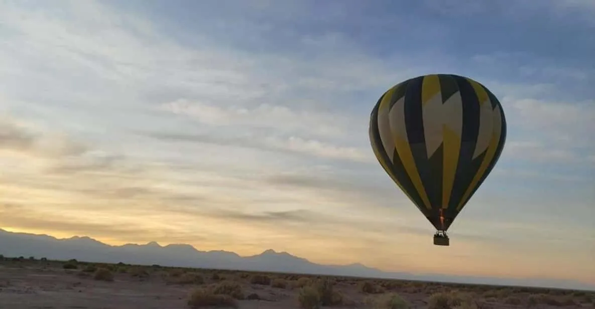 Hot air balloon floating at sunrise over the Atacama Desert on a balloon tour near San Pedro de Atacama, Chile