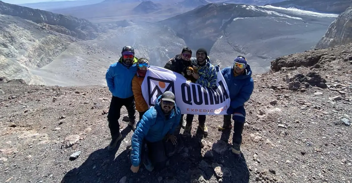 Climbers approaching the steaming crater rim of Láscar volcano on a guided Atacama Desert volcano tour in Chile