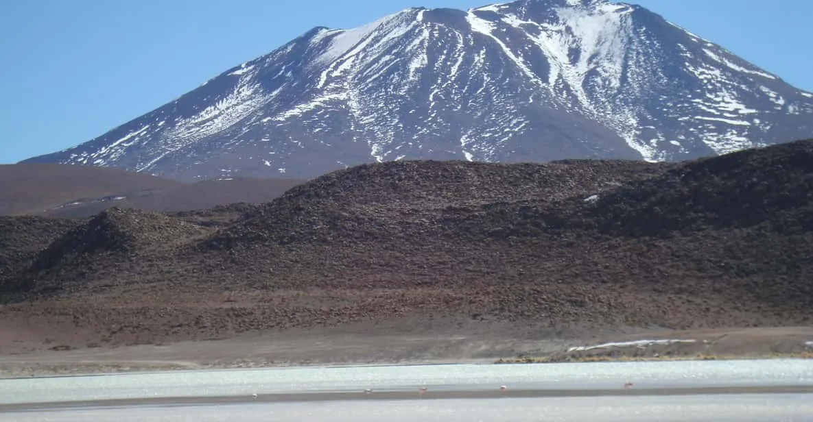 4x4 crossing the white expanse of the Uyuni salt flats on a 3-day Atacama Desert tour from San Pedro de Atacama